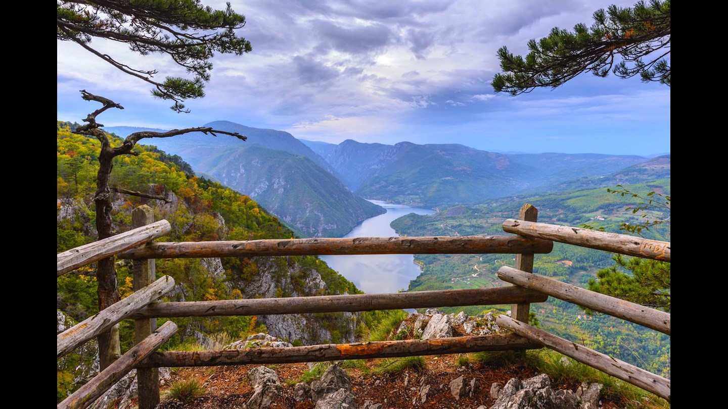 Wood fence overlooking mountains & lake in Serbia